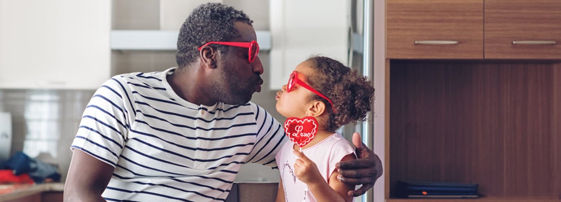 dad and little daughter about to kiss
