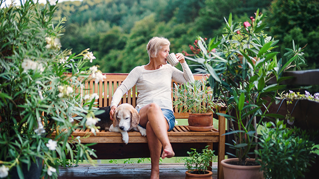 woman sitting on bench sipping out of mug