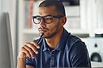 man looking at a laptop