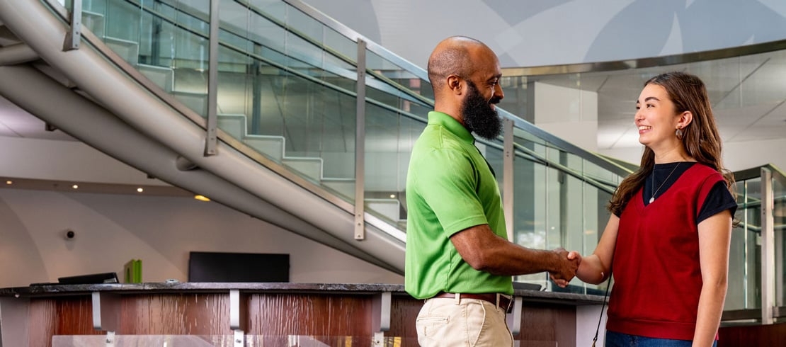 Delta Community employee greeting a customer