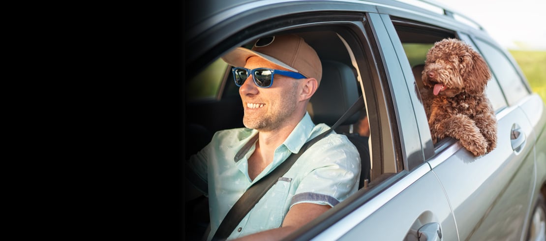 man in car after getting car loan from Delta Community Credit Union