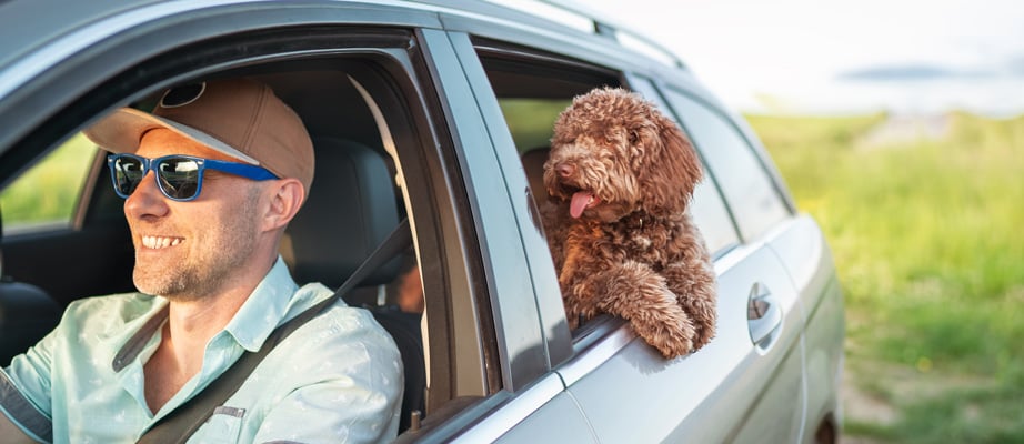 man in car after getting car loan from Delta Community Credit Union