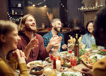 group of friends dining out and laughing together