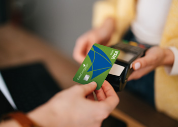 Delta Community debit card being tapped