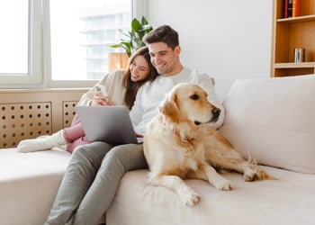 couple and their dog on the sofa