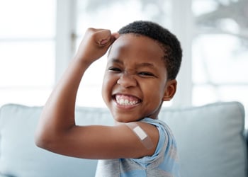 little boy flexing his muscle