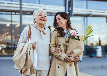 older woman smiling with younger woman