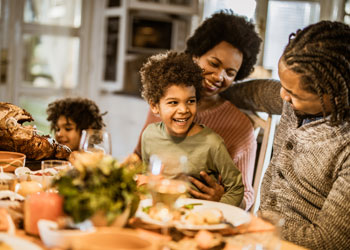 family at a dinner table laughing
