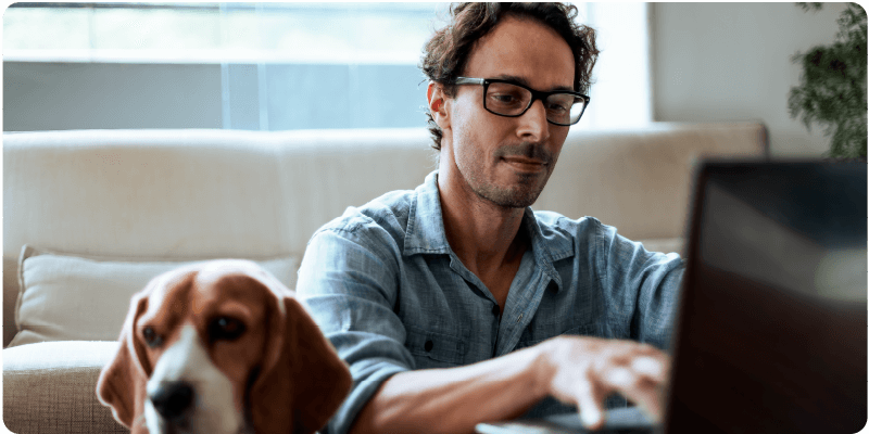 man and woman laughing and looking at tablet