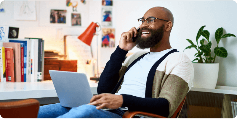 man and woman laughing and looking at tablet