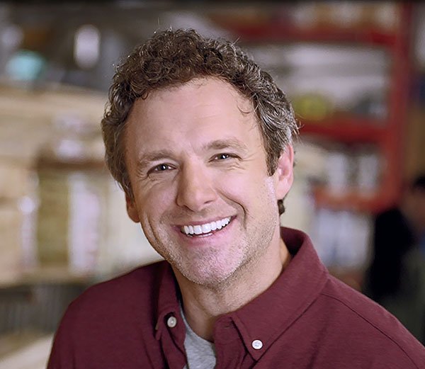 man smiling in TV ad