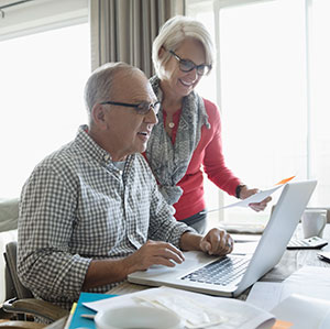  couple with laptop paying bills 