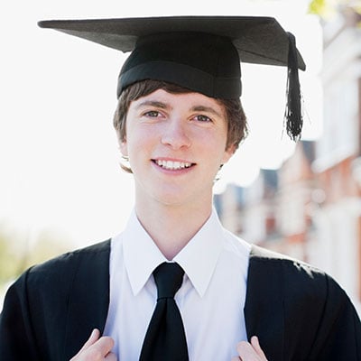 Young man graduating in his cap and gown 