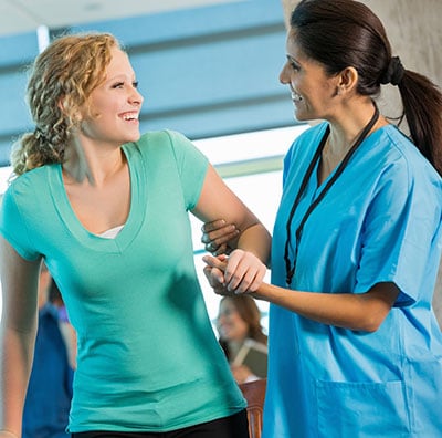 nurse helping woman 