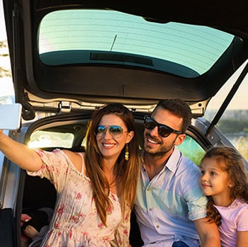 Family sitting in back of car