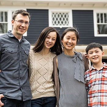 Family in front of house