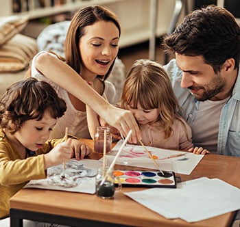 Parents with two children painting