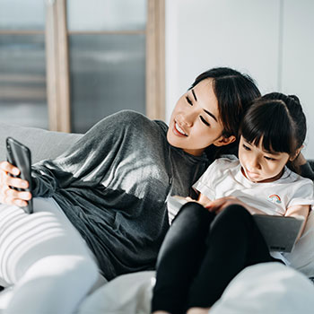 woman and child using electronic devices