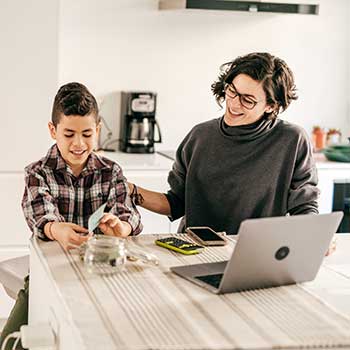 Mom teaching young son about money