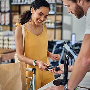 woman paying for groceries