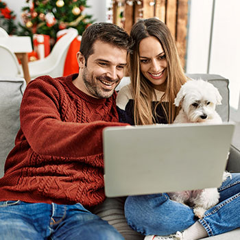 friends with dog looking at computer