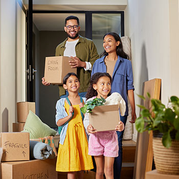 family walking into new home
