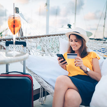 woman on vacation using credit card