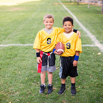 two young friends playing flag football