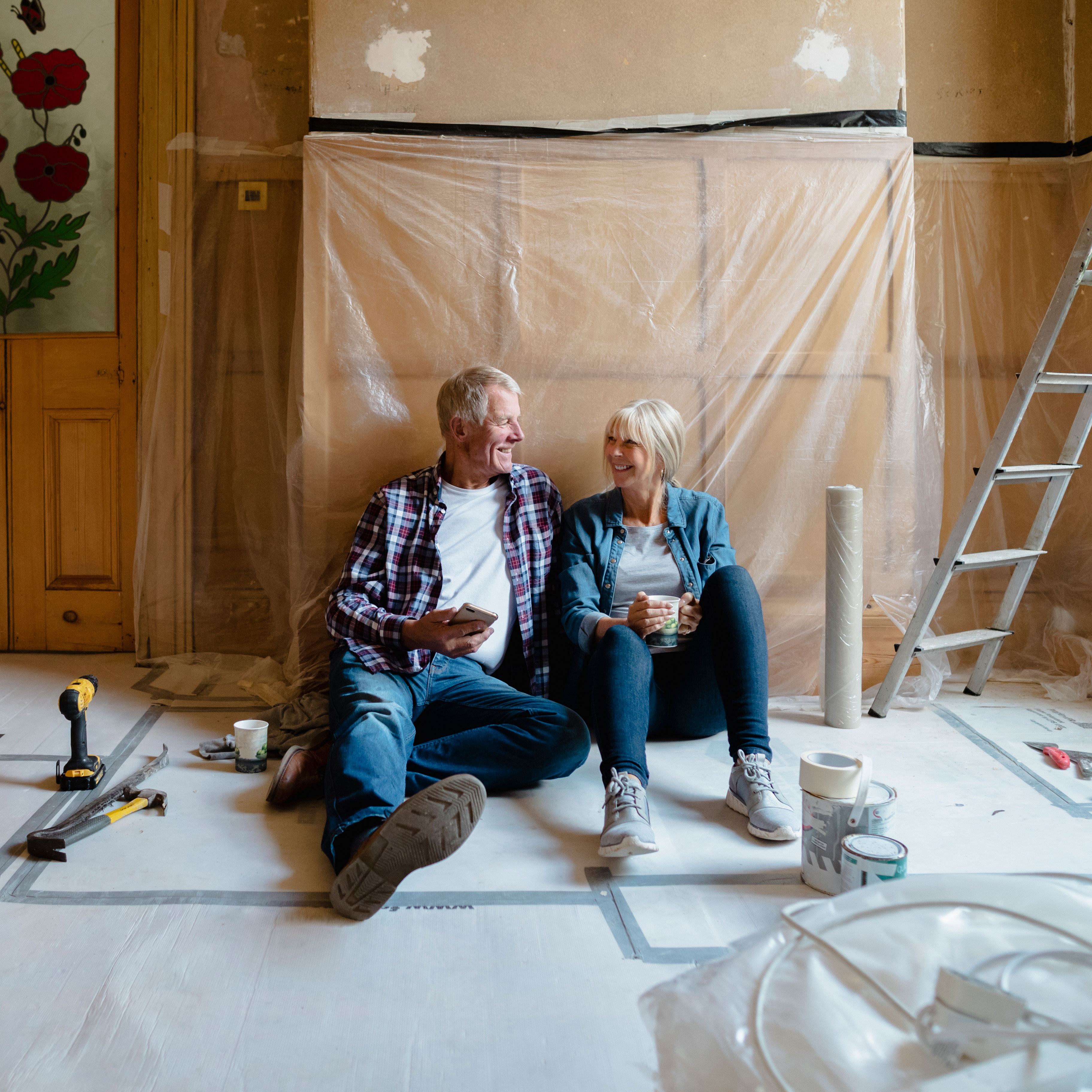 couple sitting in home being renovated