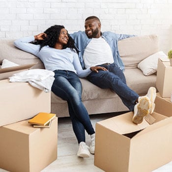 couple sitting on couch in new home