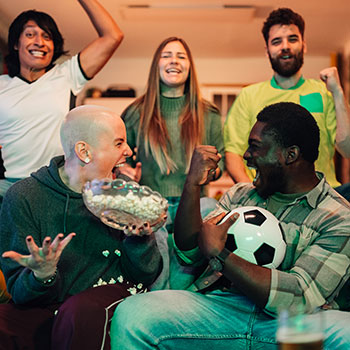 friends watching soccer and celebrating