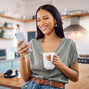 woman looking at mobile phone and smiling