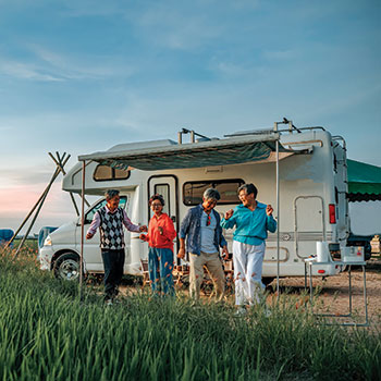 family dancing outside of an RV
