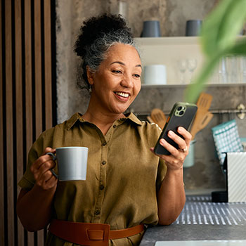 woman smiling and looking at cell phone