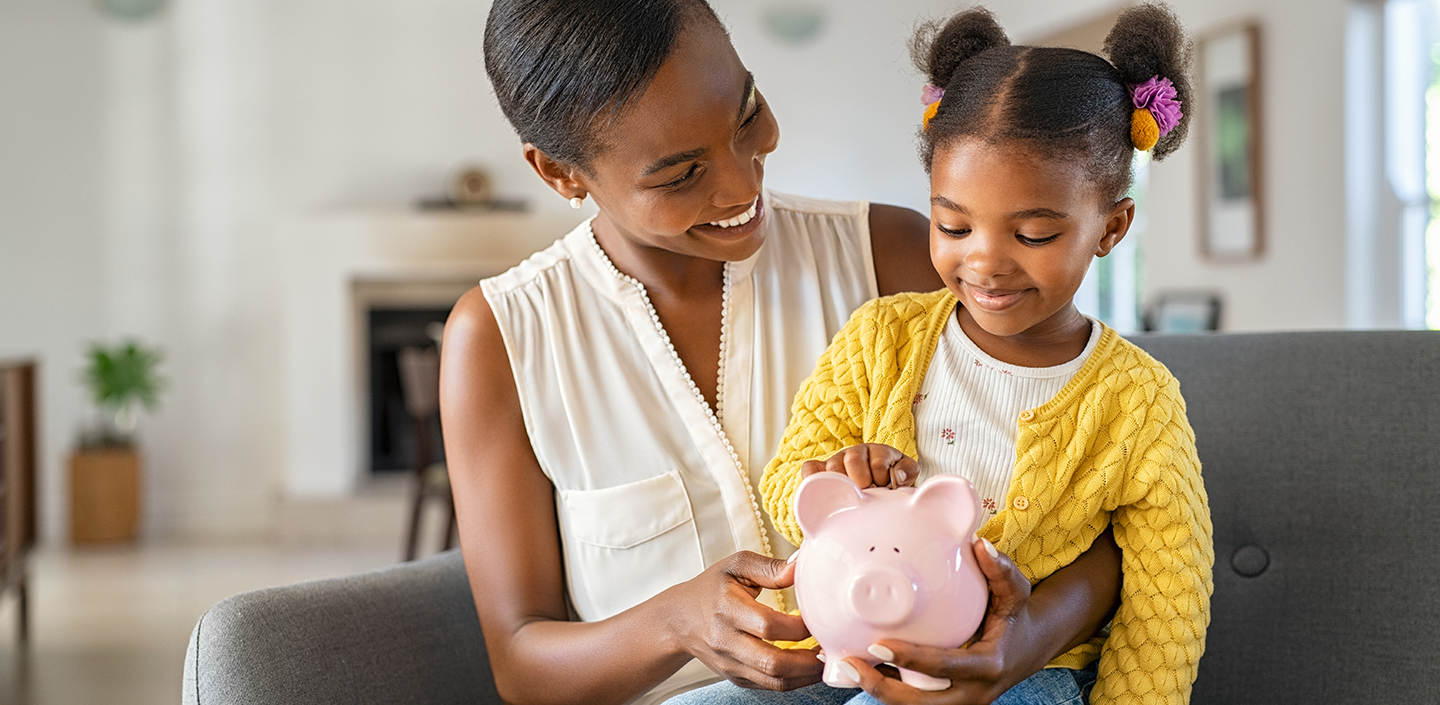 mother and child with piggy bank