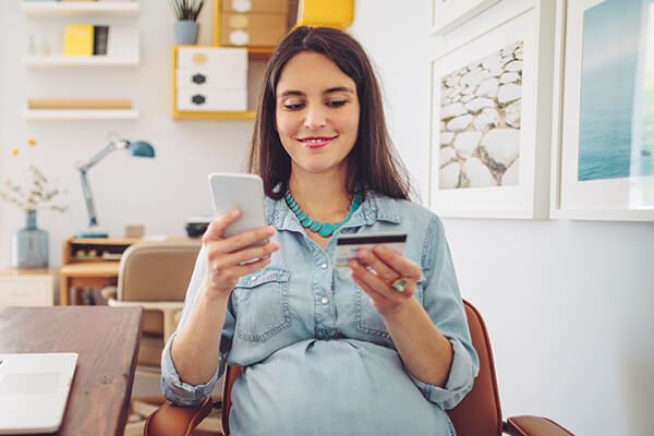 woman looking at additional crdit card benefits on mobile