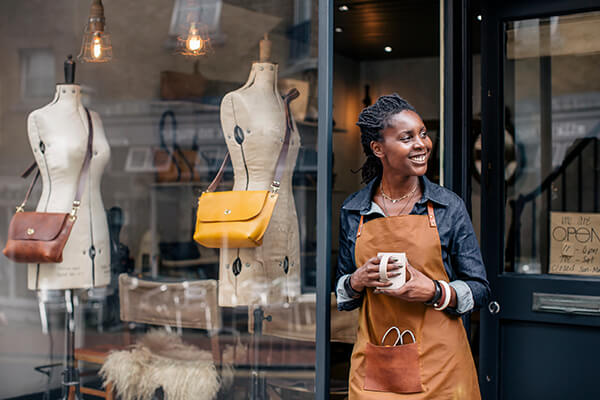 female entrepreneur stands outside her store