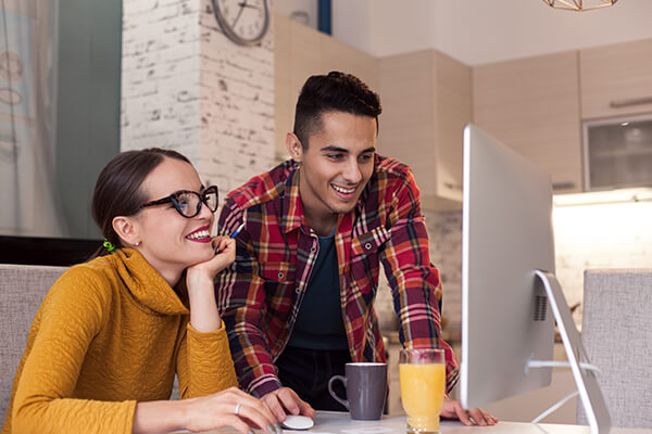 happy couple working on computer together