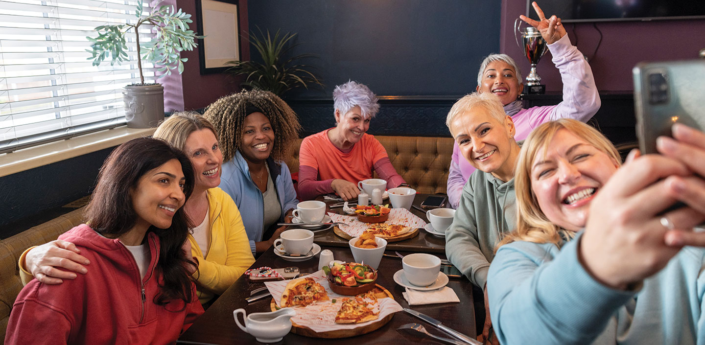 friends taking selfie at restaurant