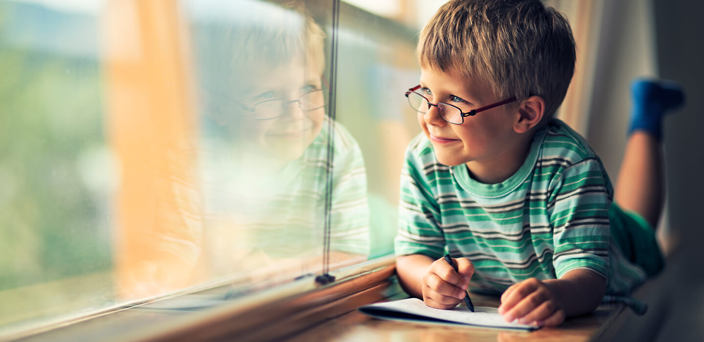 little boy having fun writing