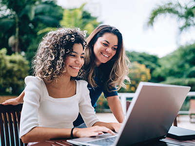 two teenage girls looking at a computer