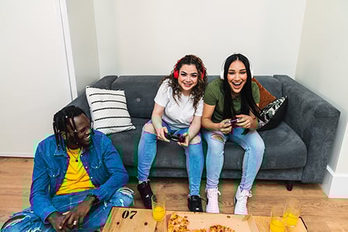 teenage friends playing video games
